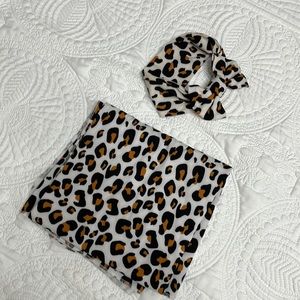 Leopard print swaddle and matching headband.
